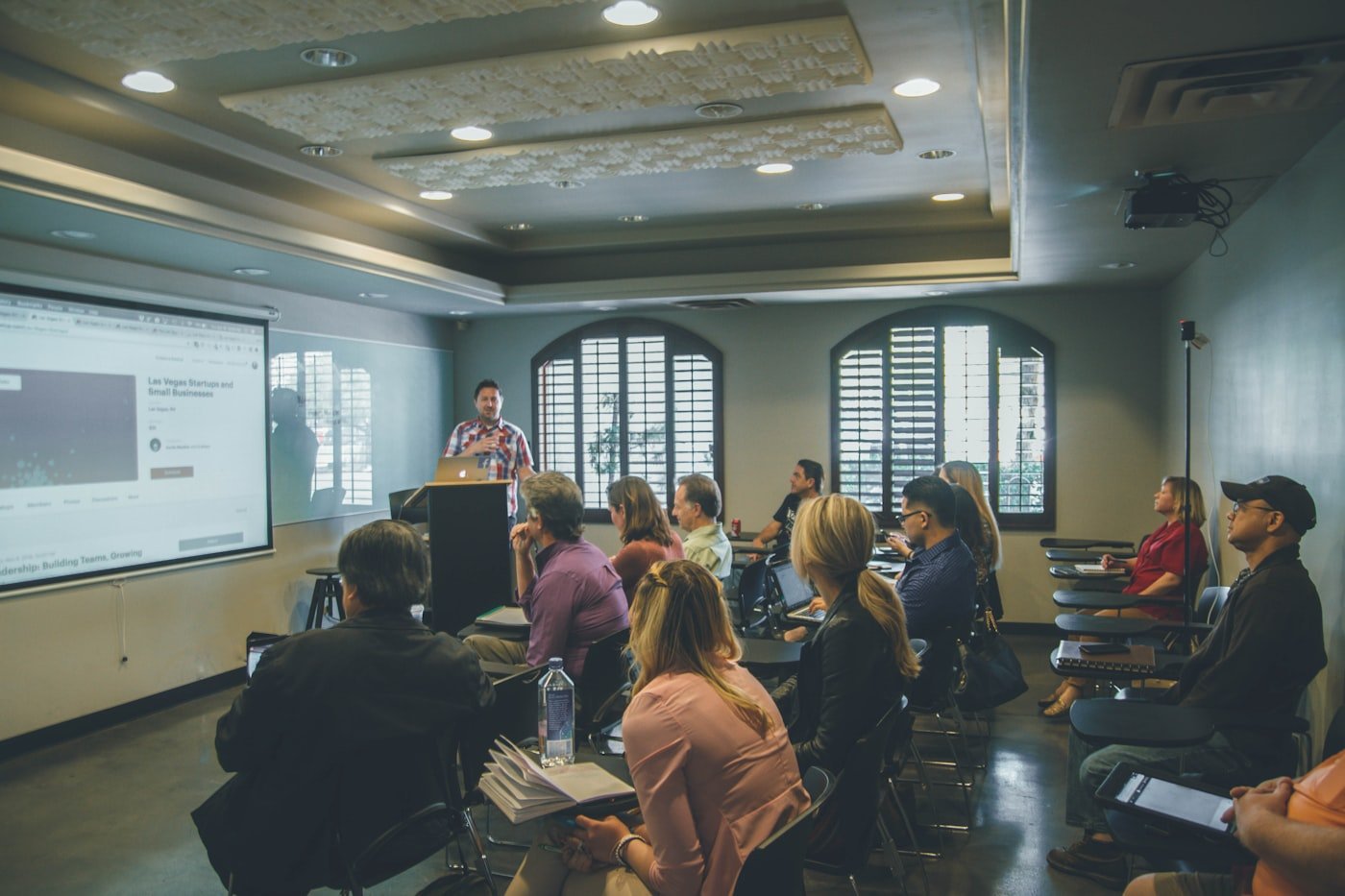 Care staff attending a group training session in a seminar room